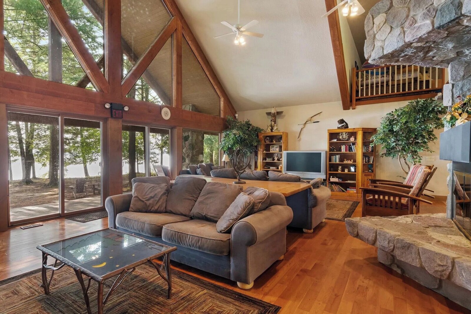 Lodge living room with a large sectional, stone fireplace and gathering space